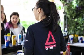 A woman in a Pyramid Canteen t-shirt serves customers