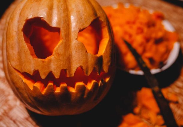 A carved pumpkin with a candle inside