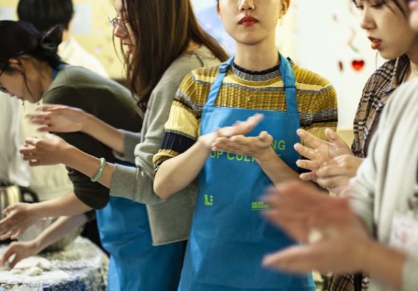 A woman rolling dough at a Culture Cooks event