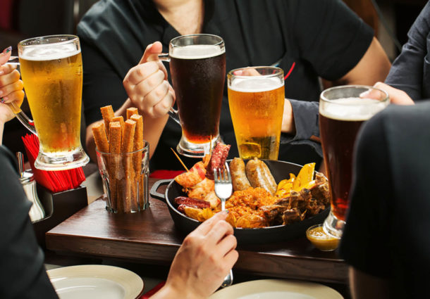 Image of several men with beer and pub fod