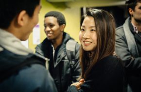 Two Postgraduates chat at a social event