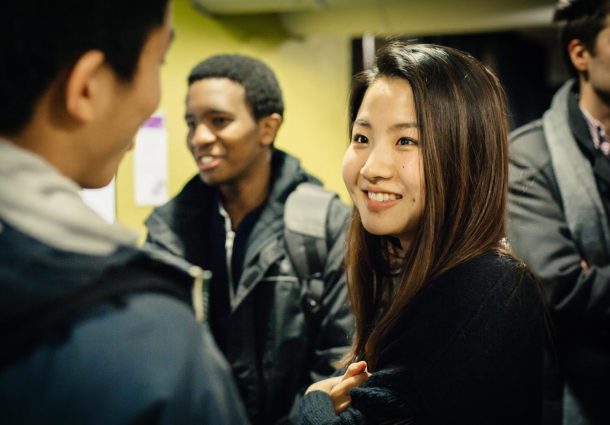 Two Postgraduates chat at a social event