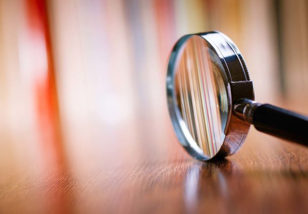 Closeup of a magnifying glass on a wooden table