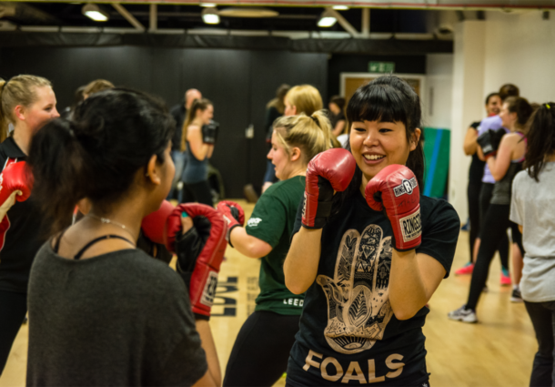 Two women sparring during a boxing session